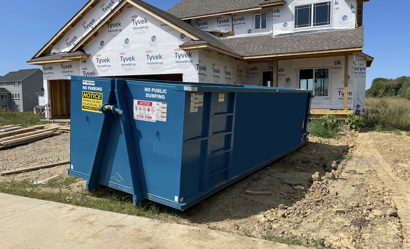 blue dumpster is being rented for commercial job site
